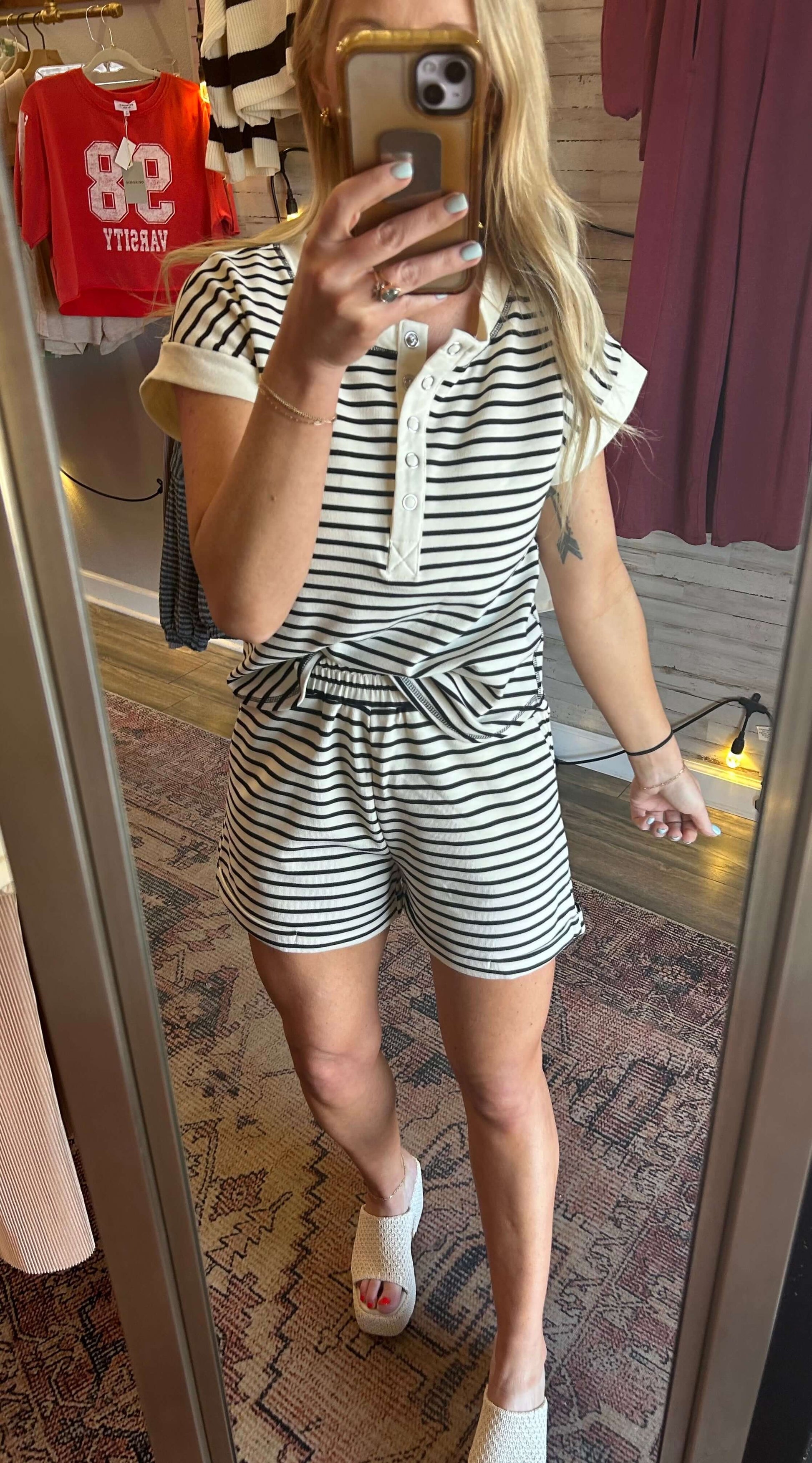 Woman wearing a Snap Henley 2pc Stripe Set in cream, featuring elastic waist shorts and a cap sleeve button down top.