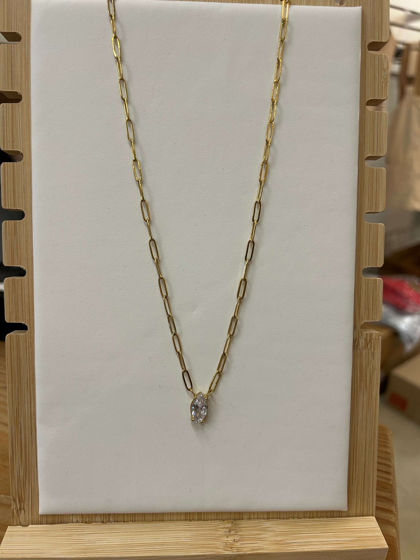 Gold diamond pendant necklace on display, water-resistant with a lifetime warranty, 16-18 inches adjustable length.