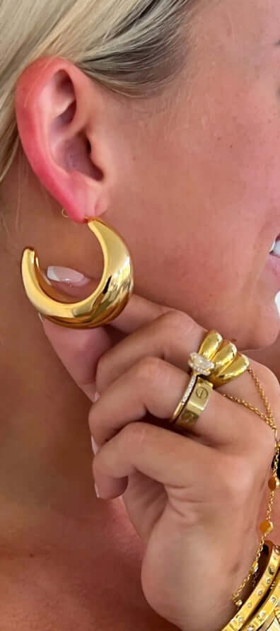 Model wearing Blake Gold Hoops, 18k gold plated earrings, showcasing lightweight and water-resistant design.