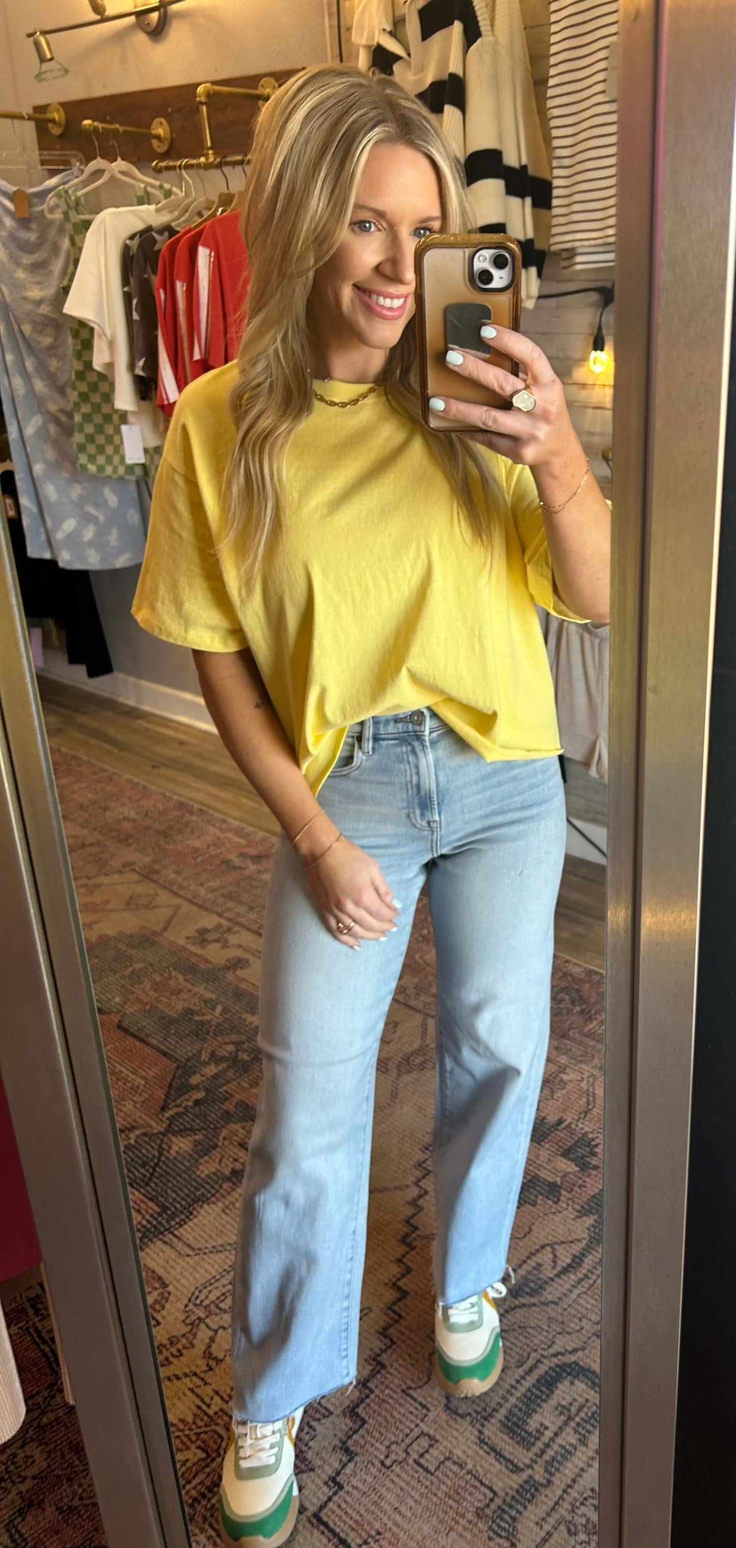 Model wearing HIDDEN Logan Highrise Dad Jeans in light wash with a yellow tee, showcasing raw hem and wide leg fit.