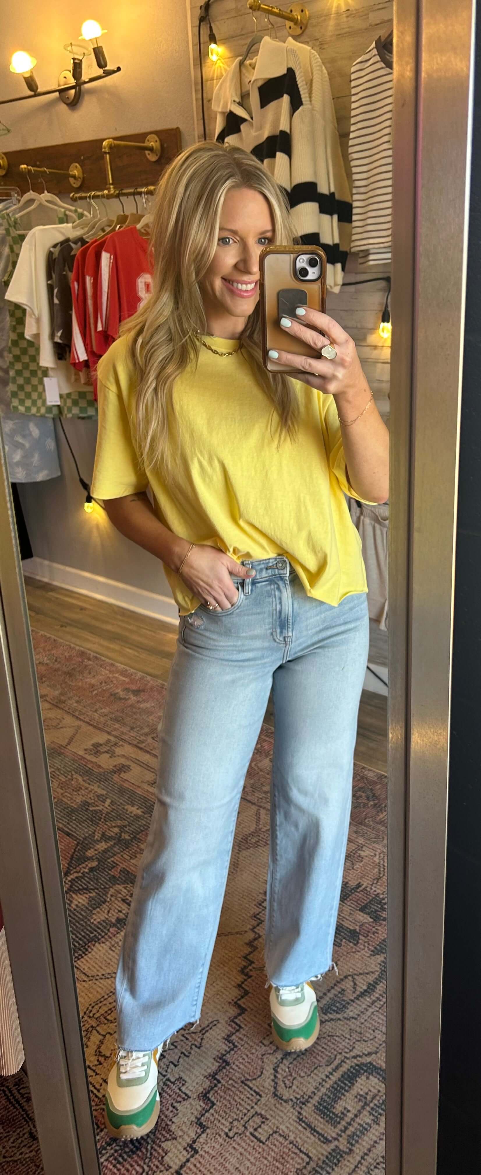 Model wearing light wash HIDDEN Logan Highrise Dad Jeans and yellow top, showcasing trendy spring fashion with wide leg style.