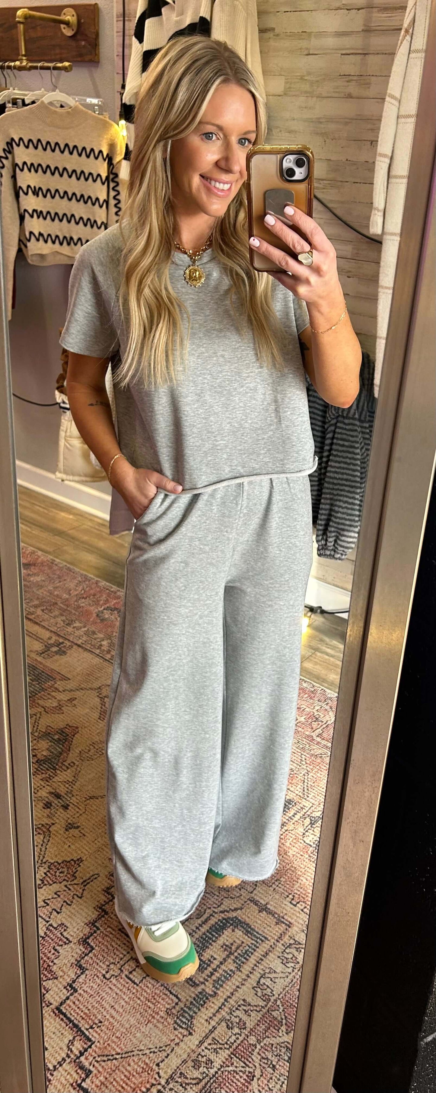 Woman wearing a heather grey wide leg tee shirt set in a casual summer setting, showcasing comfort and style.