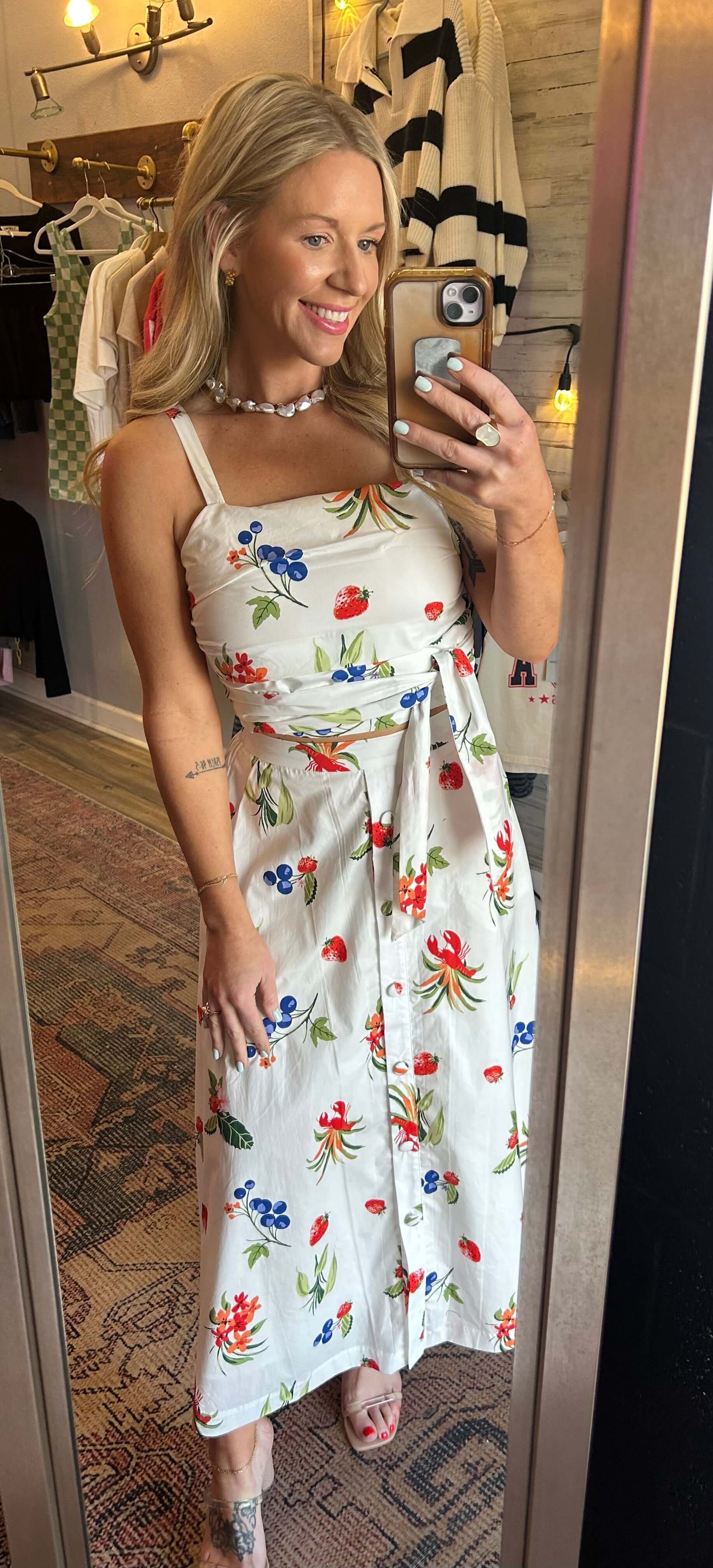 Model wearing a floral 2pc skirt set with adjustable straps and elastic waist, perfect for summer style.