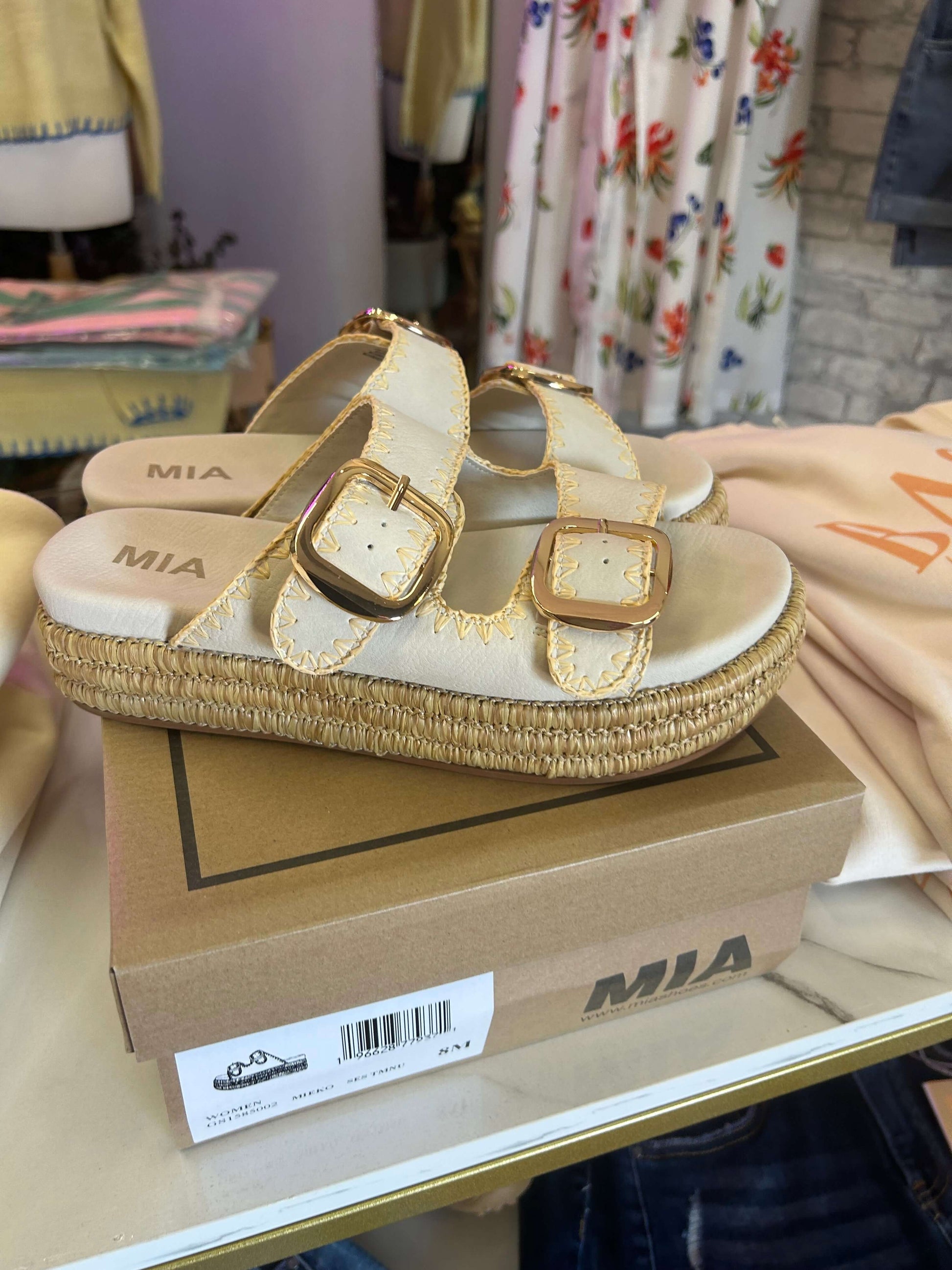 MiA Mieko Seashell sandals showcasing vegan leather with gold buckles and raffia-wrapped sole on display.