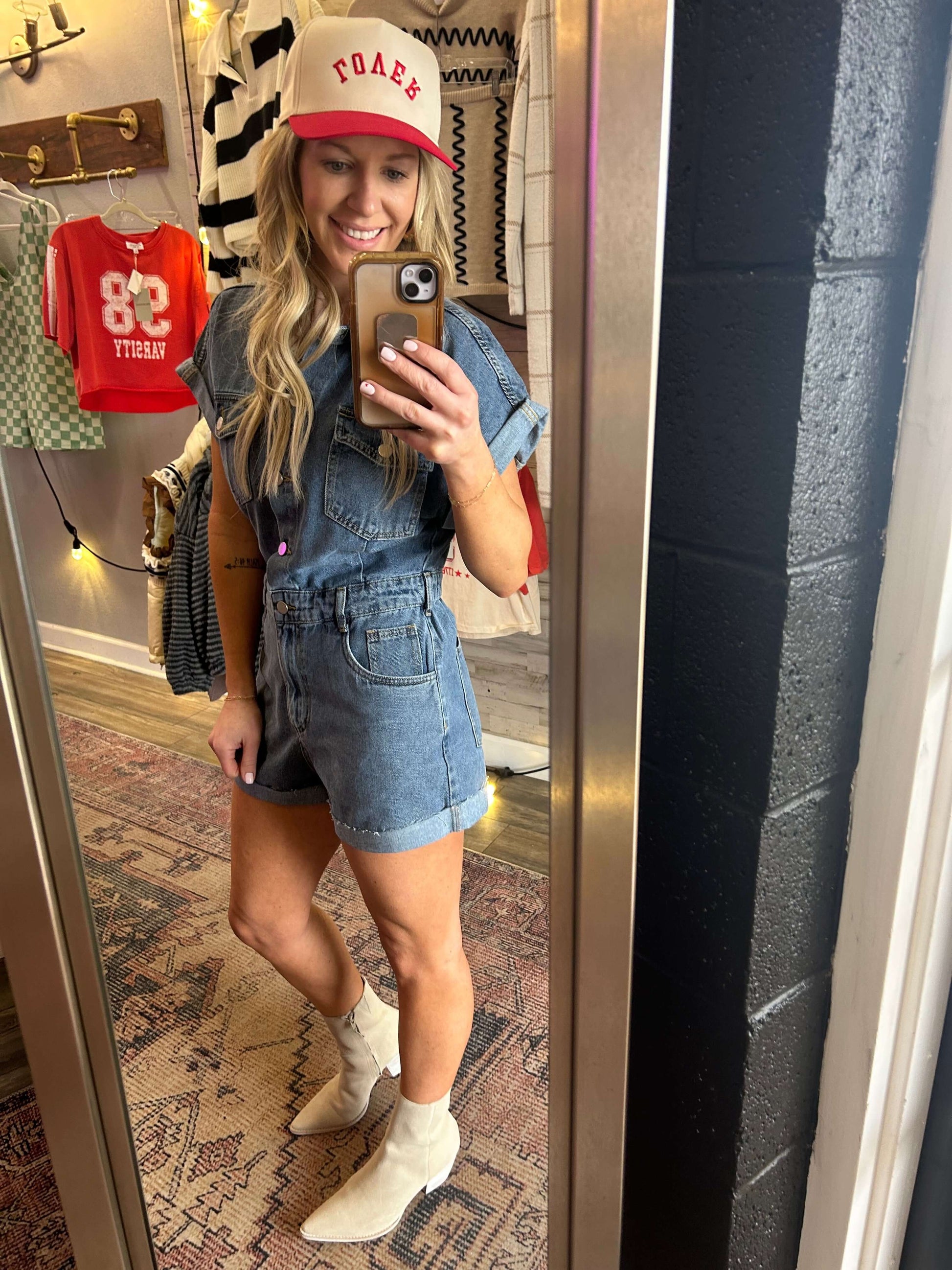 Denim Days Button Down Romper featuring cuff hem, flattering elastic back and zipper fly in a stylish mirror selfie.