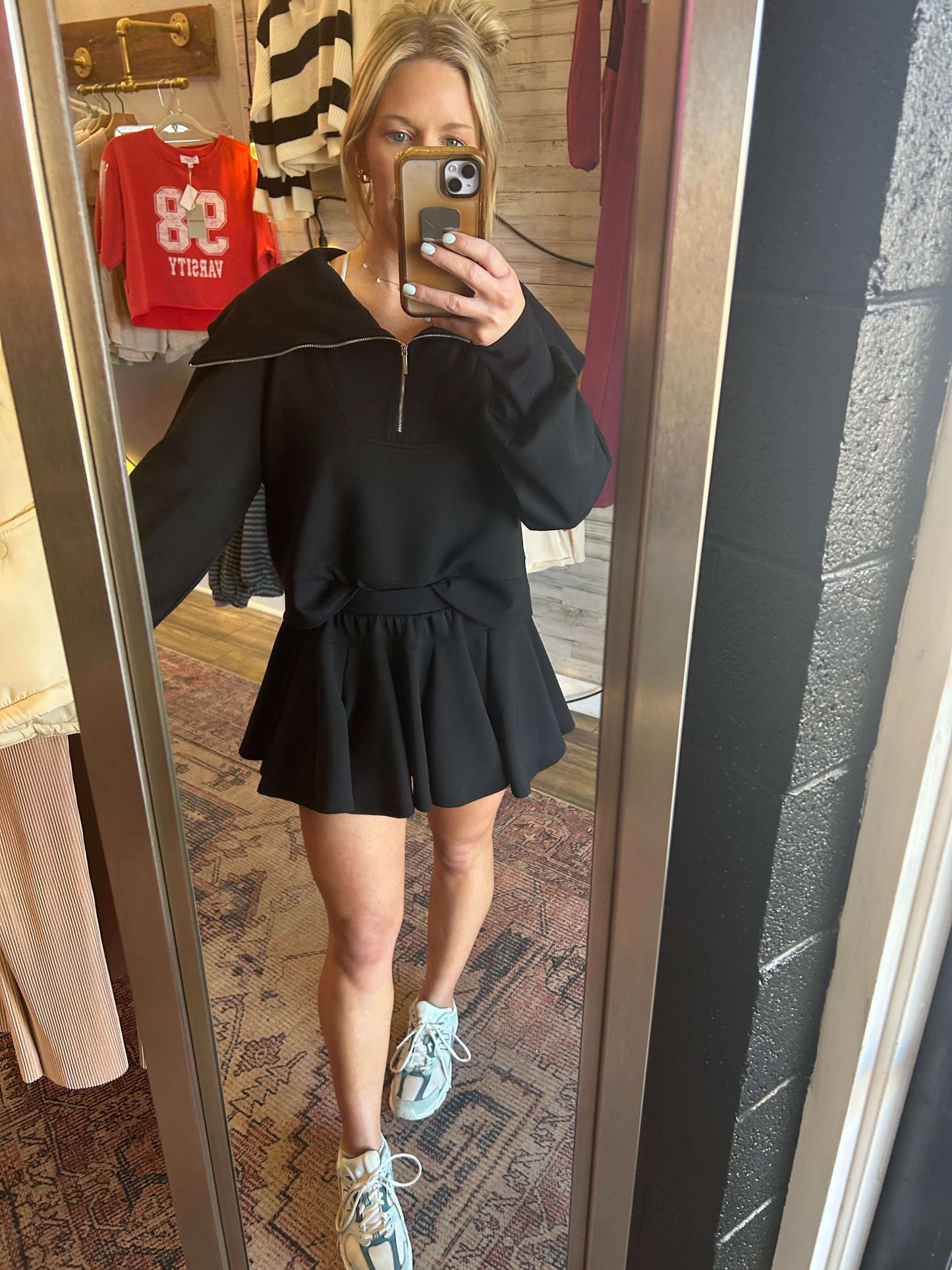 Cowl turtleneck neoprene pullover with half zip, paired with black flare skort and built-in shorts.