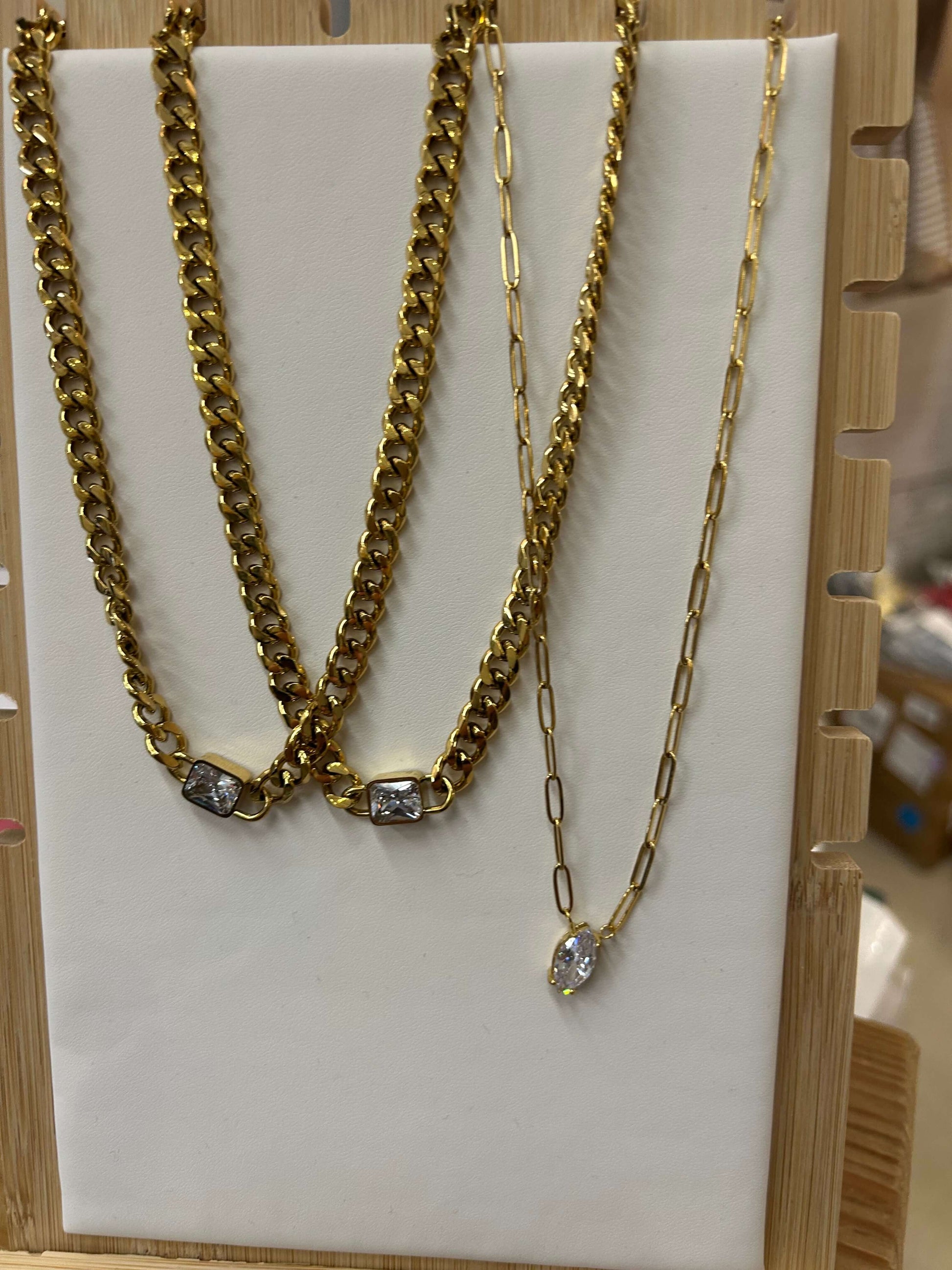 Stylish chain necklaces featuring a diamond pendant, gold-plated stainless steel, and adjustable lengths for versatility.