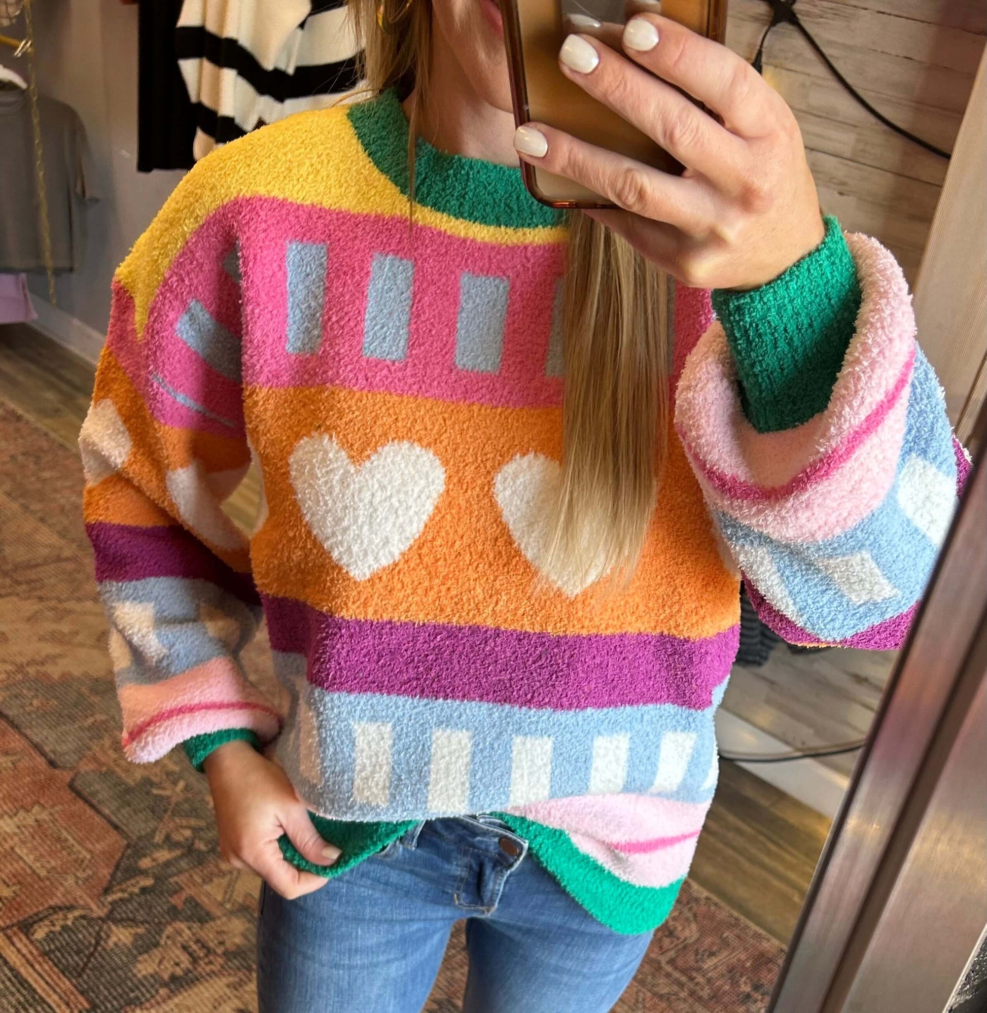 Colorful patterned hearts knit sweater, perfect for winter and Valentine's Day, featuring soft, cozy material.