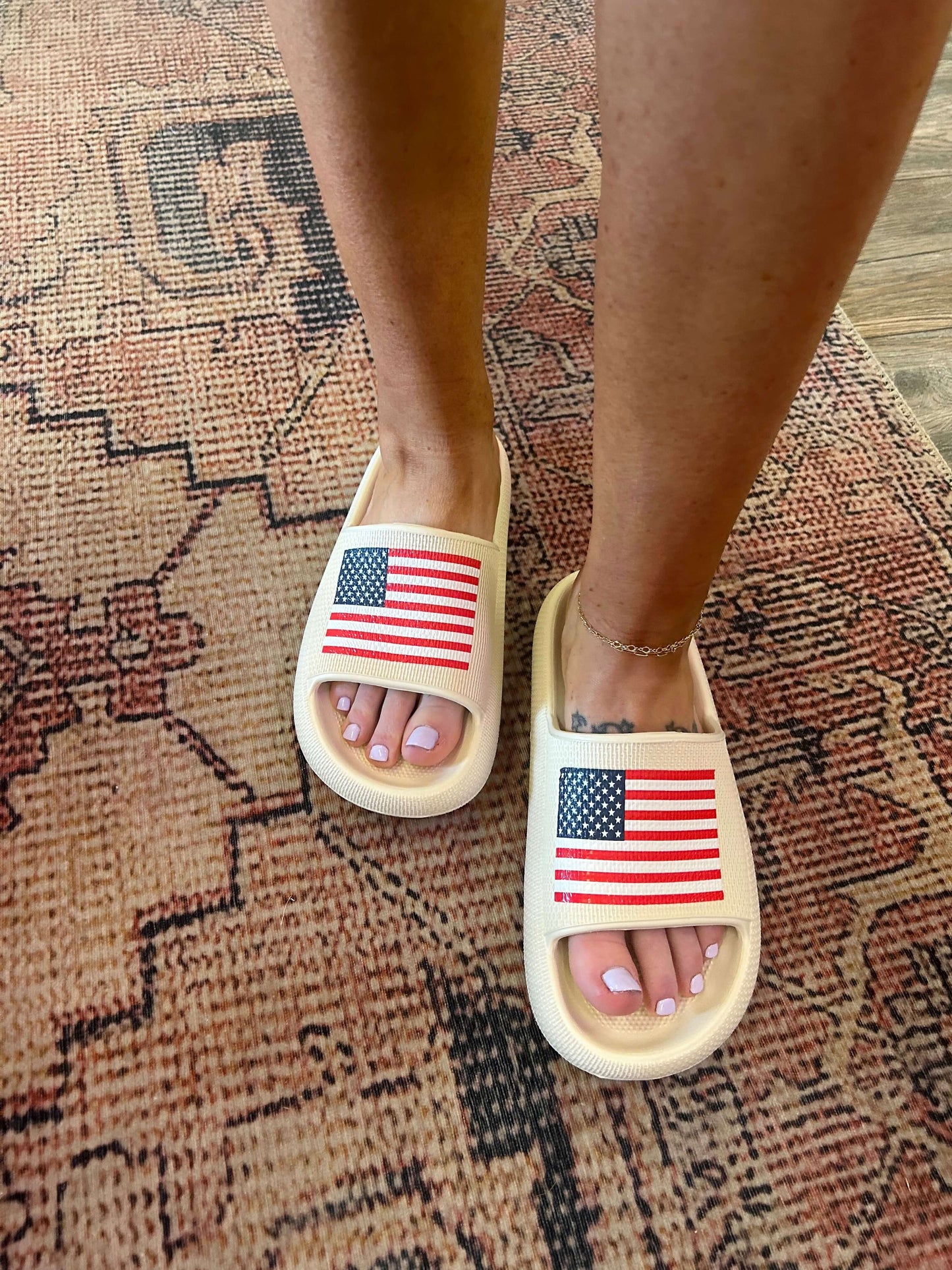 MIA American flag pool slide sandals worn on feet, perfect for summer style and comfort, featuring a bold flag design.