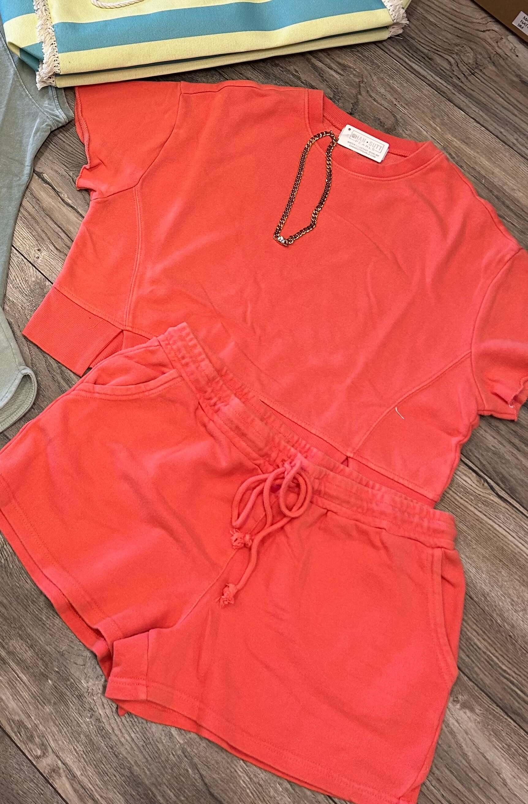 Summer sunset coral 2pc short set, featuring a short-sleeve top and drawstring shorts with pockets.
