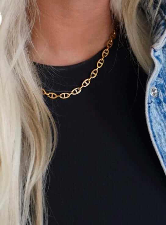 MIA Necklace featuring water-resistant 18k gold plated stainless steel, showcased on a model with a stylish outfit.