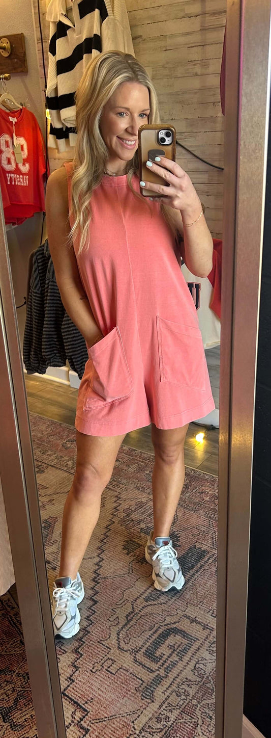 On the Go Romper in coral, featuring high neck, buttons at the back, and a casual fit for summer outings.