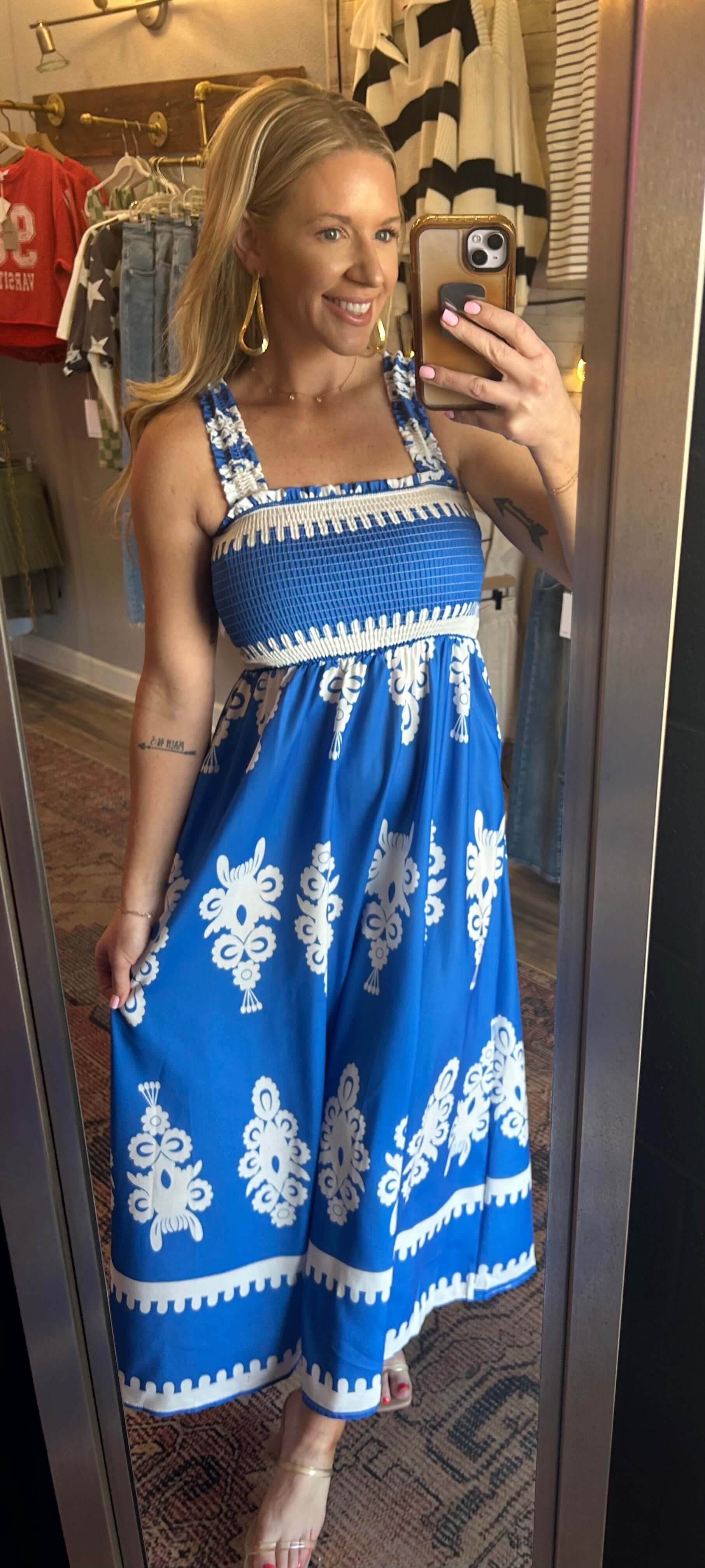 Woman wearing a blue smocked printed maxi dress, showcasing its summer style, perfect for beach trips and special occasions.